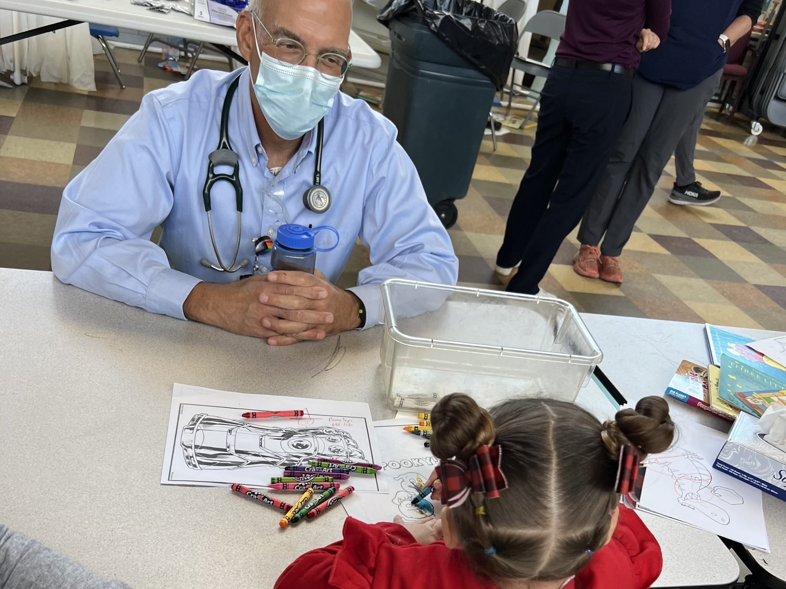 Dr. Richard Backman, associate professor for the Physician Assistant Program enjoys some coloring with a Head Start student.